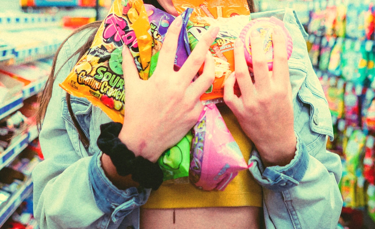 how long does it take to kick sugar addiction, picture of a woman holding bags and bags of candy to her heart