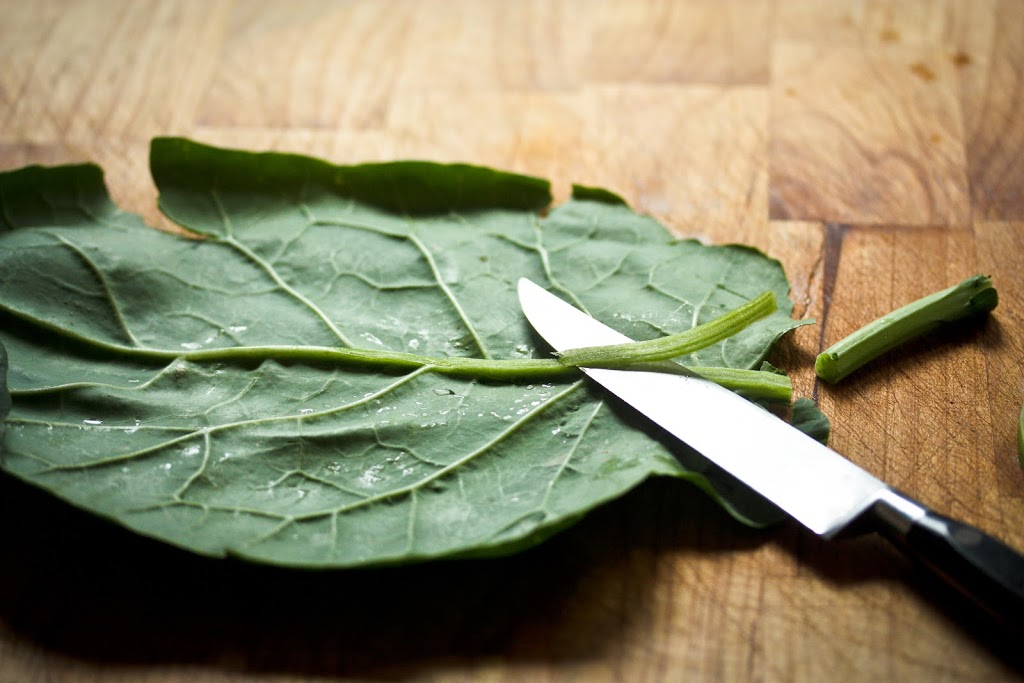 Wash and dry collard leaves. Cut the stems where the leaf stops and de-vein the stem so it is thin like the leaf.  Example below: 