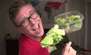 man enjoys eating a bowl of raw vegetable salad